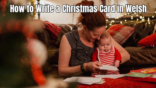 Person writing a Welsh-language Christmas card.