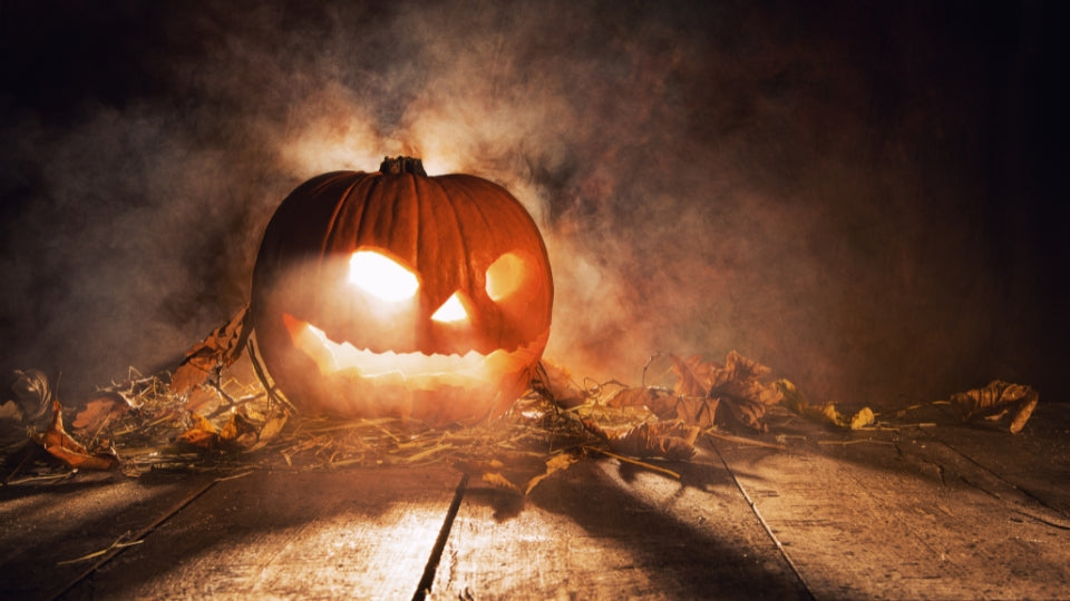 Carved pumpkin and autumn leaves for a guide to Welsh Calan Gaeaf traditions.