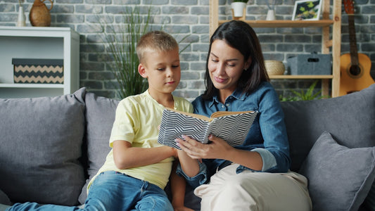 Adult and child reading a book together at home