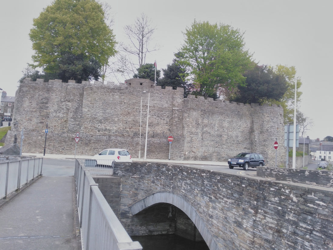 Cardigan Castle south wall and towers beneath a blue sky