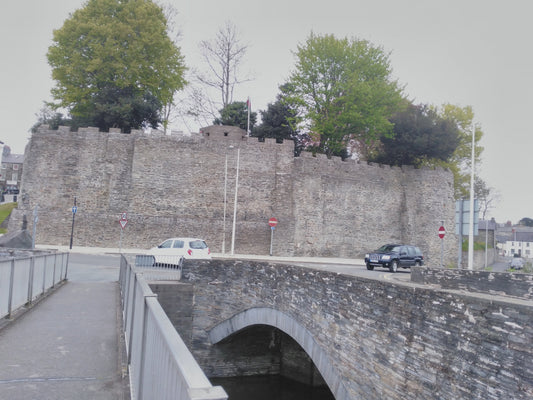 Cardigan Castle south wall and towers beneath a blue sky