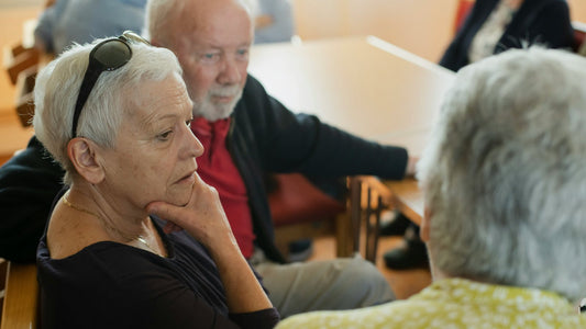 Older people talking together at a community gathering in Wales