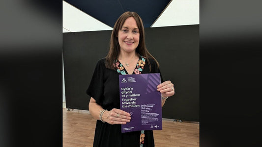 Dona Lewis holding the National Centre for Learning Welsh strategic plan