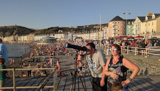 Crowds watching the partial solar eclipse from Aberystwyth promenade