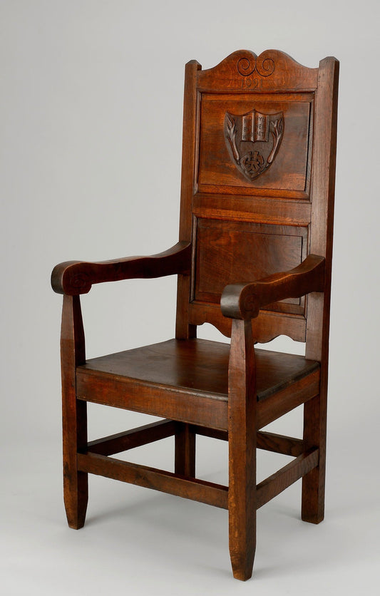 A carved wooden eisteddfod chair made for Welsh students in 1921
