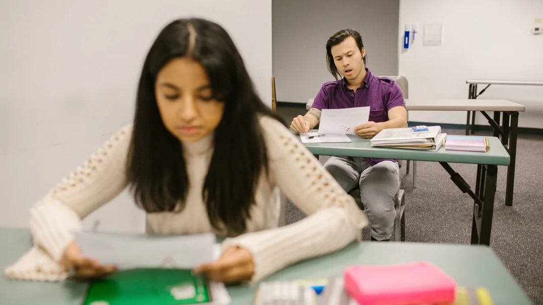 Two students reading exam results in a classroom