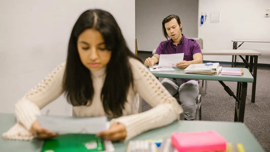 Two students reading exam results in a classroom