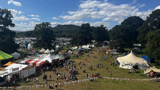 Green Man Festival site filled with crowds, stages and colourful tents in the Welsh hills