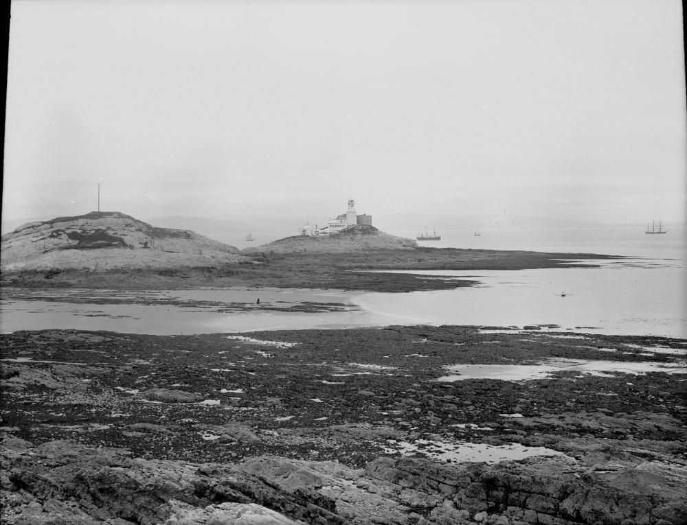 Sailing boats near Mumbles Lighthouse in Swansea Bay