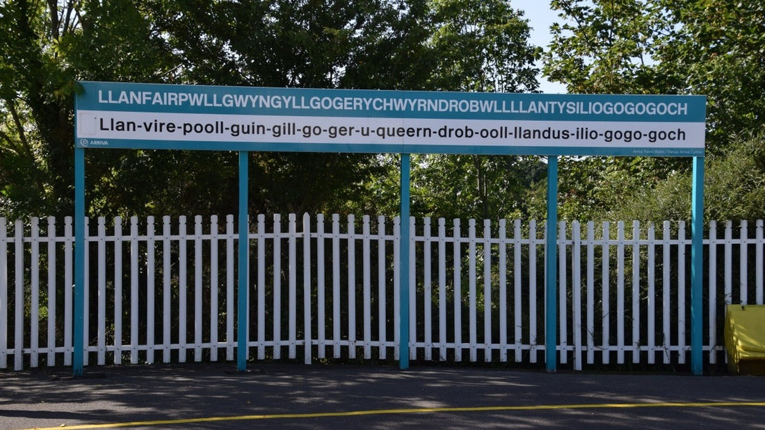 Long Welsh place-name sign at Llanfairpwll railway station on Anglesey.