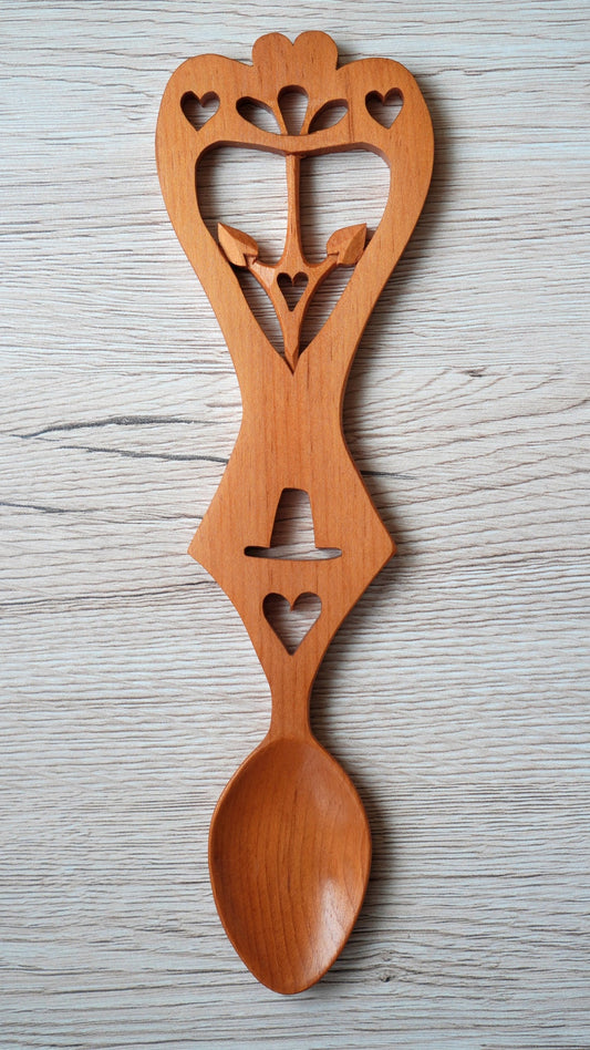 Modern carved Welsh love spoon with interlaced decoration