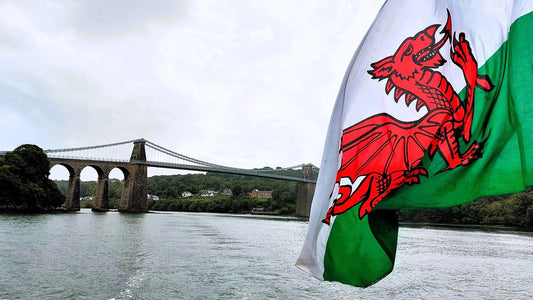 The Welsh Red Dragon flag flying beside the Menai Strait