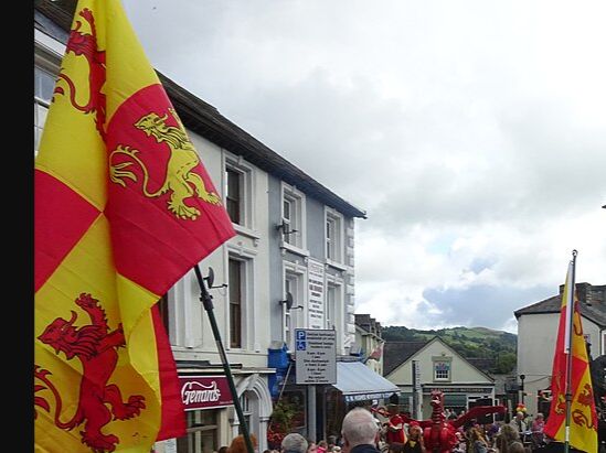 Red and gold four-lion flags carried through Corwen for Owain Glyndŵr Day