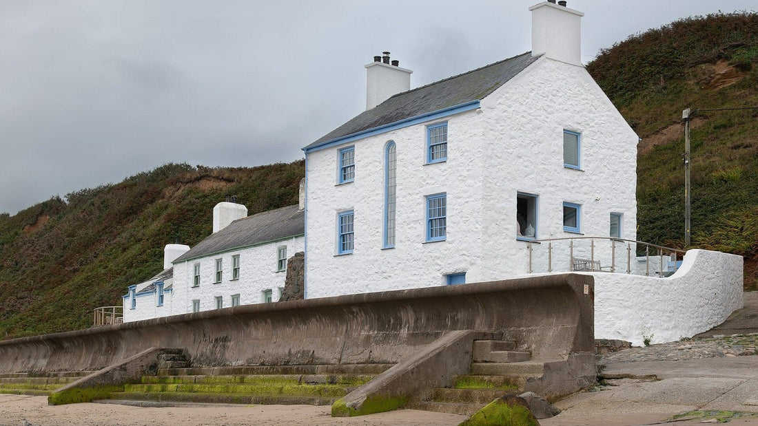 Cottages beside the beach and seawall at Morfa Nefyn in Gwynedd