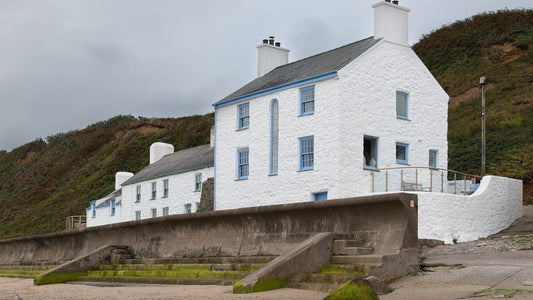 Cottages beside the beach and seawall at Morfa Nefyn in Gwynedd