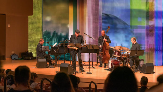 Four-piece jazz ensemble performing on a concert stage